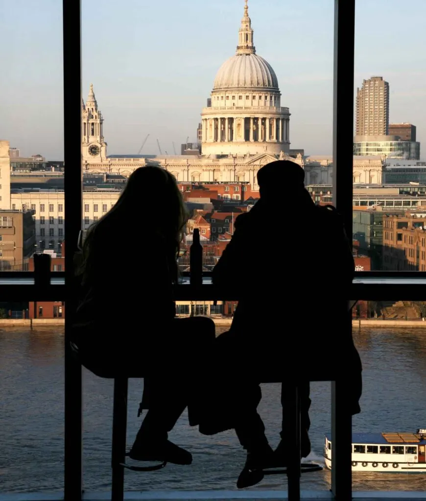 A couple tourists over looking St Paul's Cathedral from Tate Modern